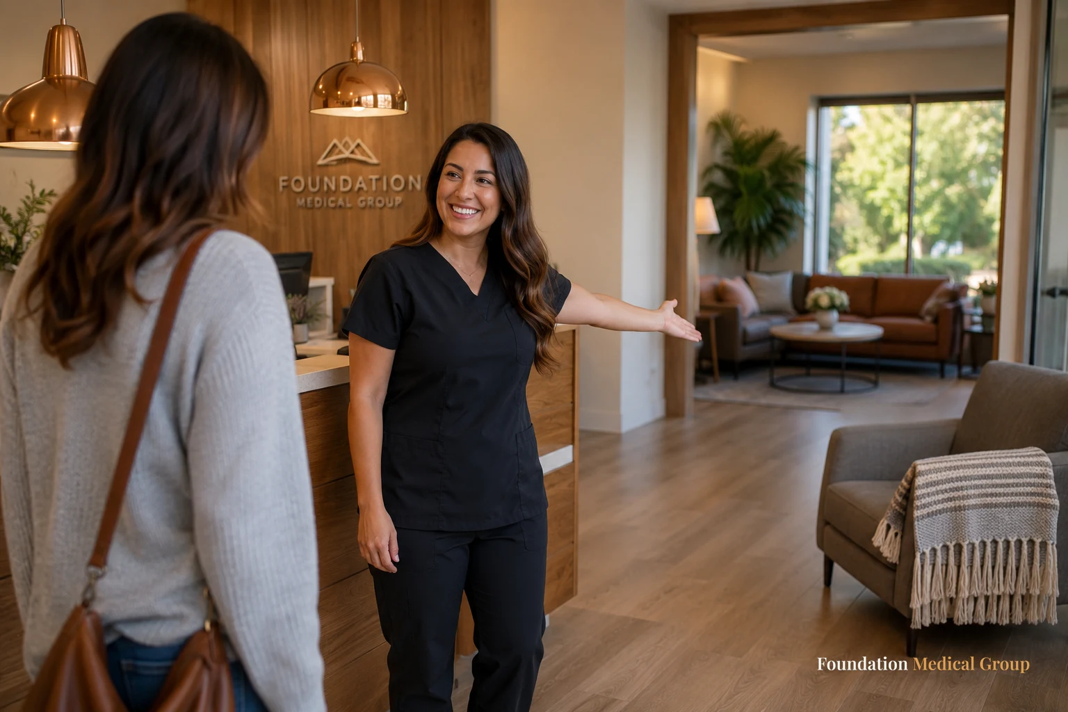 A welcoming receptionist gestures toward a bright, inviting clinic waiting area with comfortable seating and warm wood a