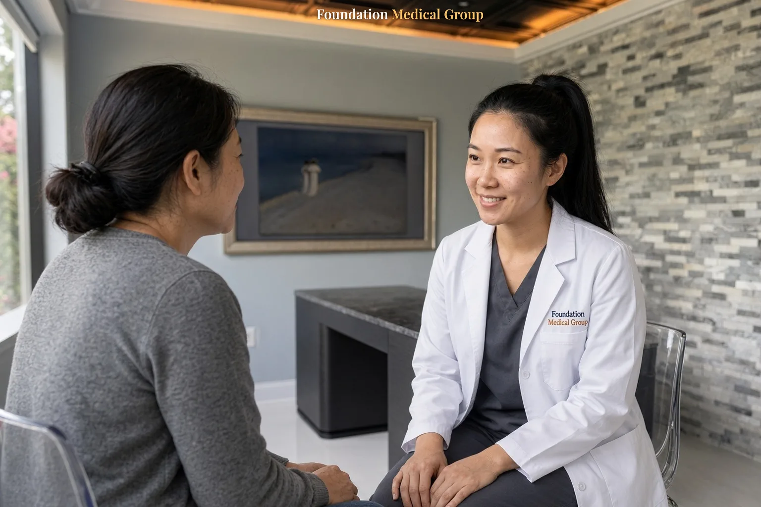 A clinician and a woman sit together during a talk therapy session for postpartum depression