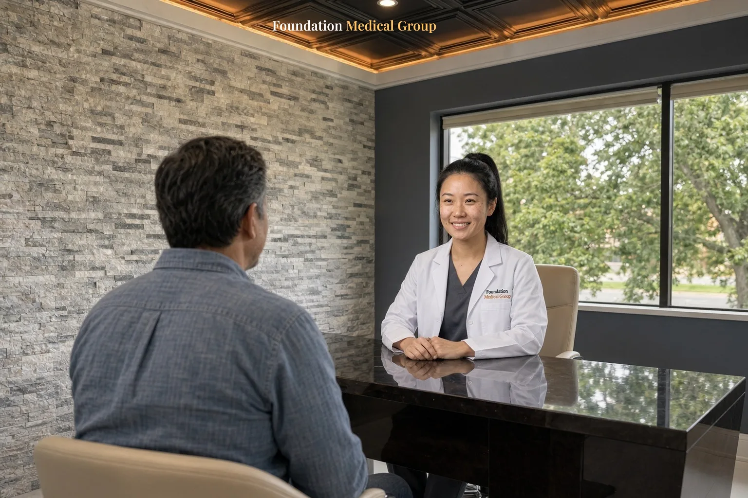 A psychiatric nurse practitioner sits at a desk and talks with a patient about a prescription plan