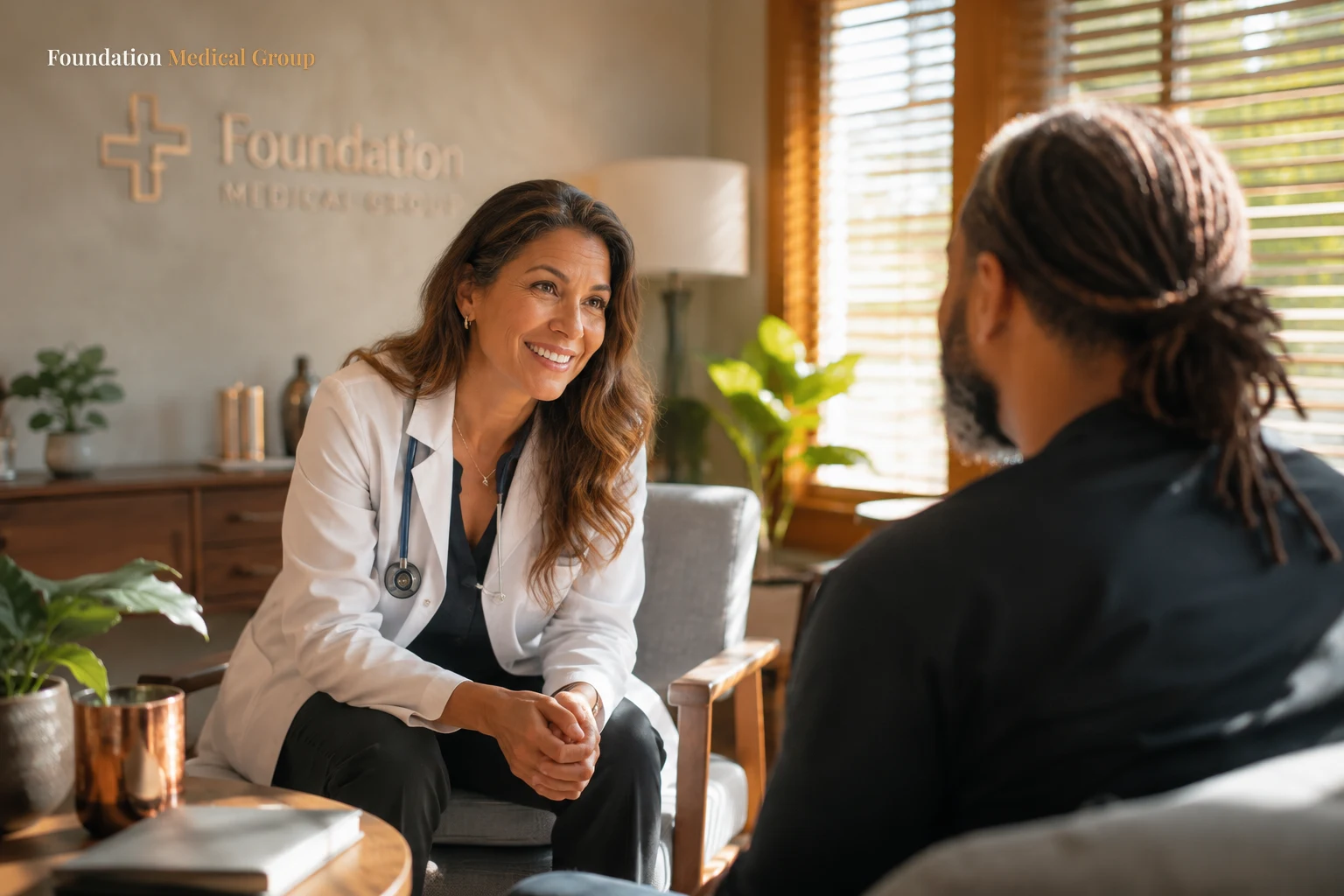 A compassionate doctor leans in with a reassuring, judgment-free smile toward a patient in a cozy, sunlit consultation r
